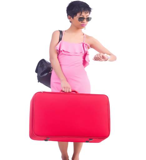 Shutterstock.com/Woman with a suitcase