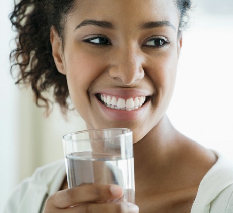 black woman drinking water