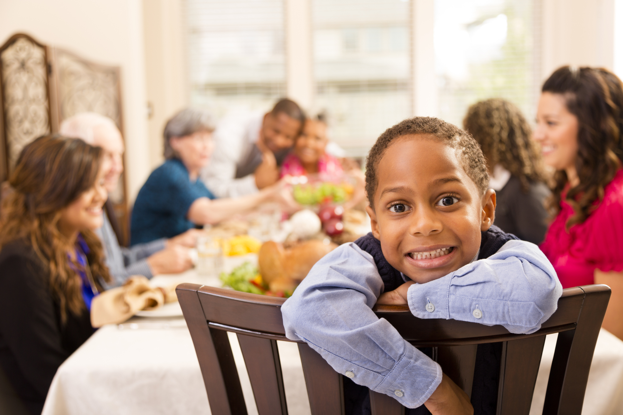 Thanksgiving: Family gathers for dinner at grandma's house. Little boy.