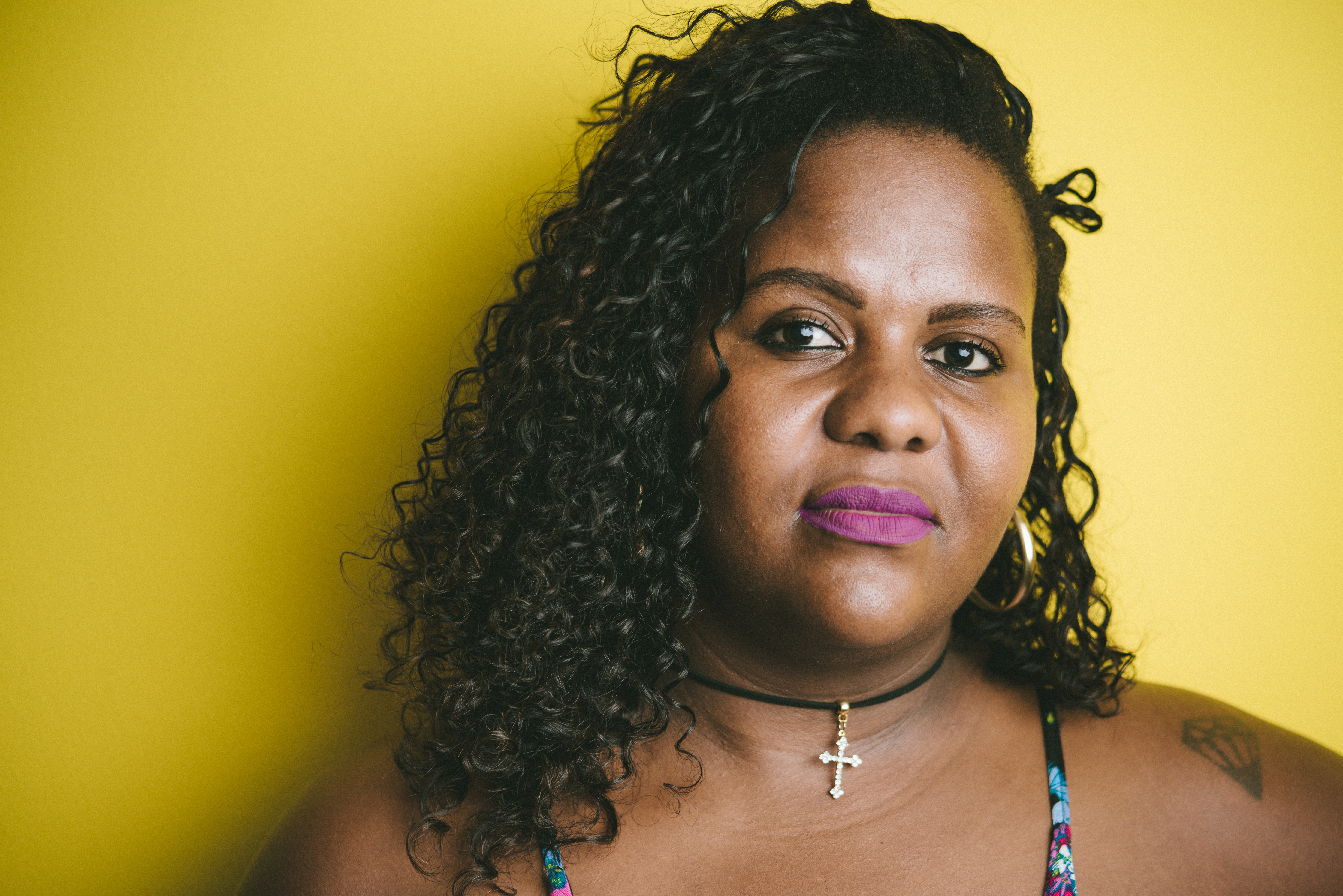 Portrait of a plus size woman on a yellow background