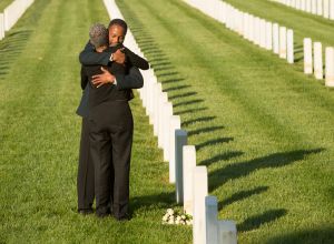 Black couple hugging at military cemetery