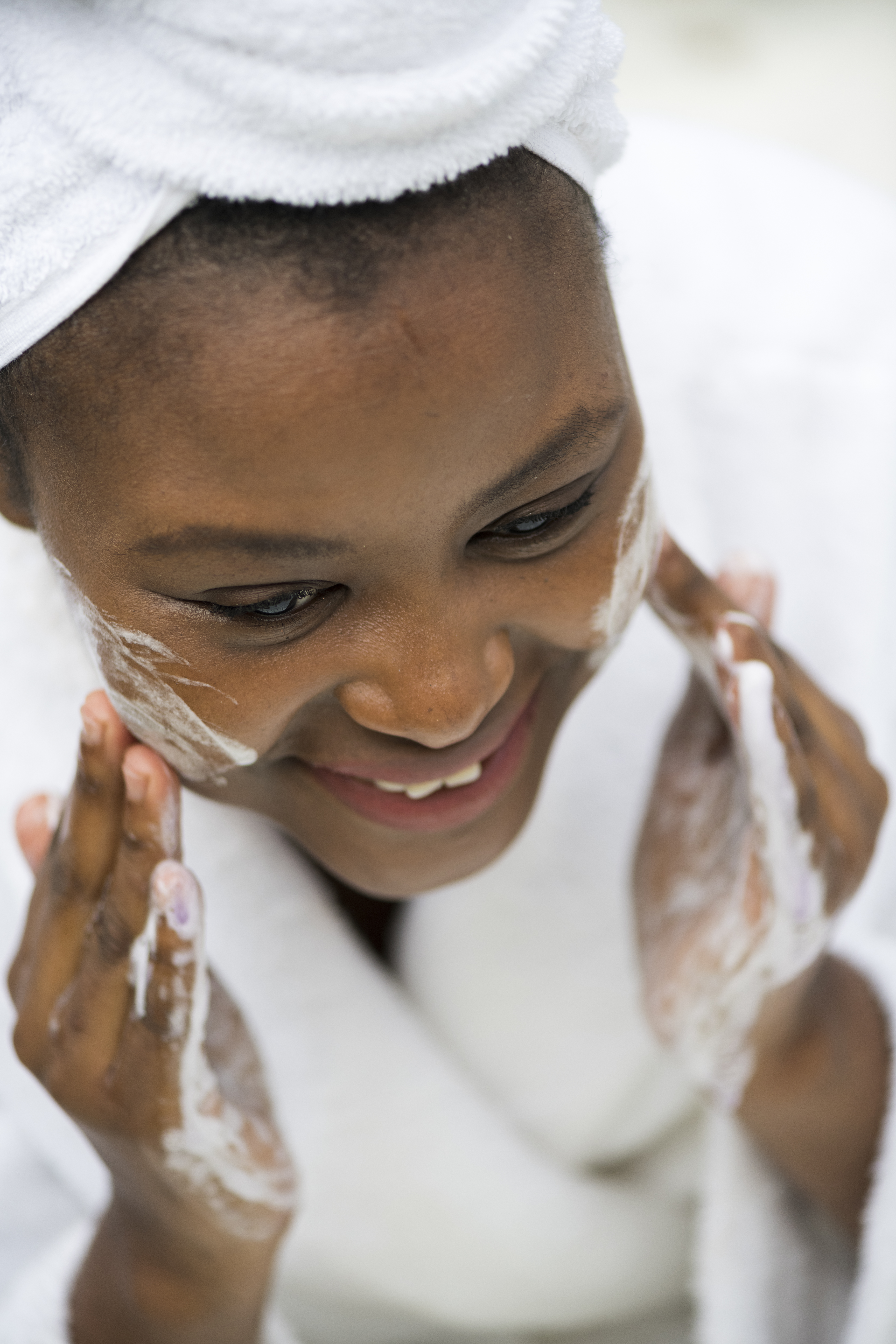 Beautiful young woman washing her face