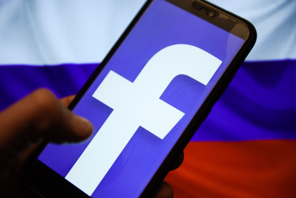 Facebook logo and Russia flag are seen on an android mobile...