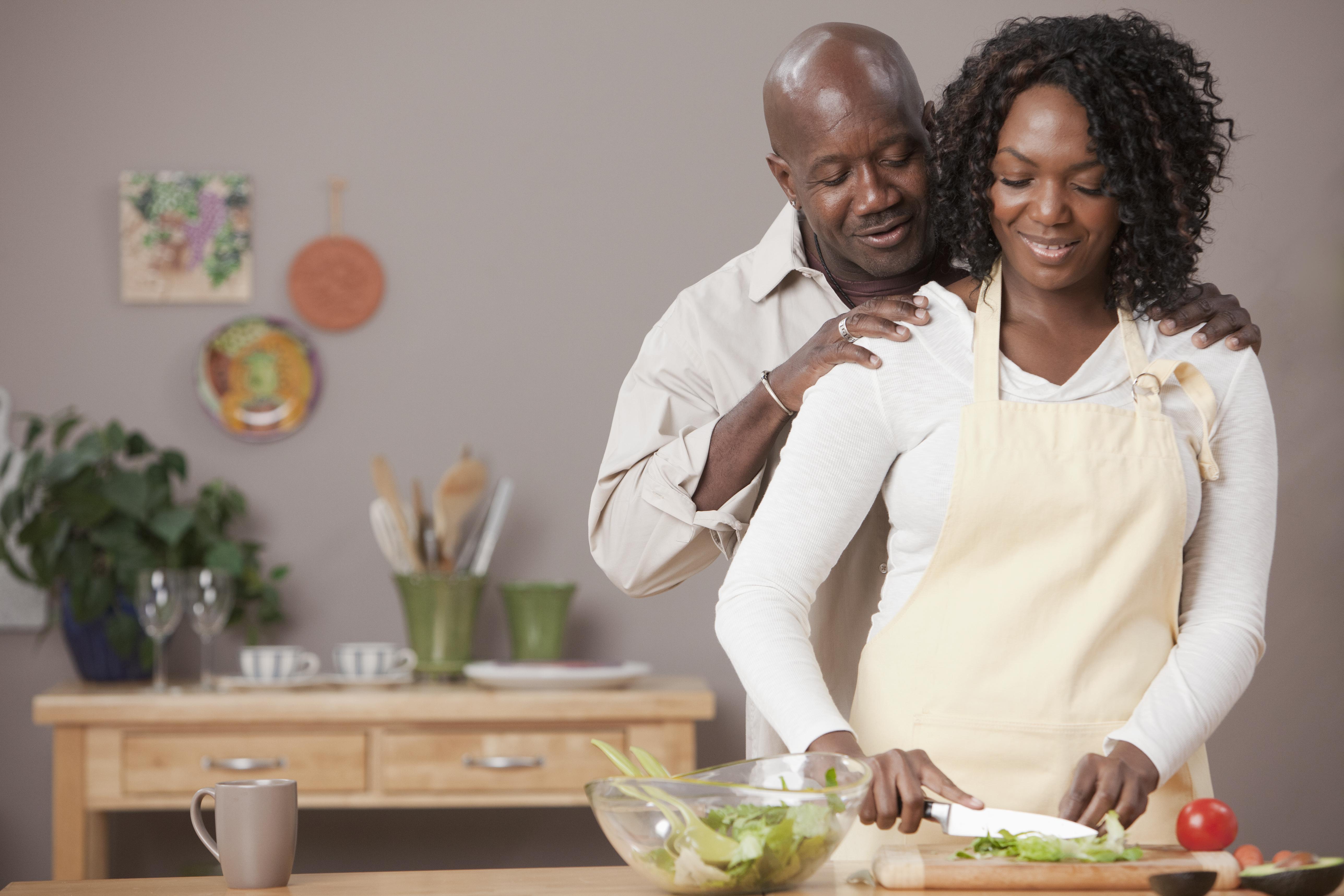 African American couple preparing salad together