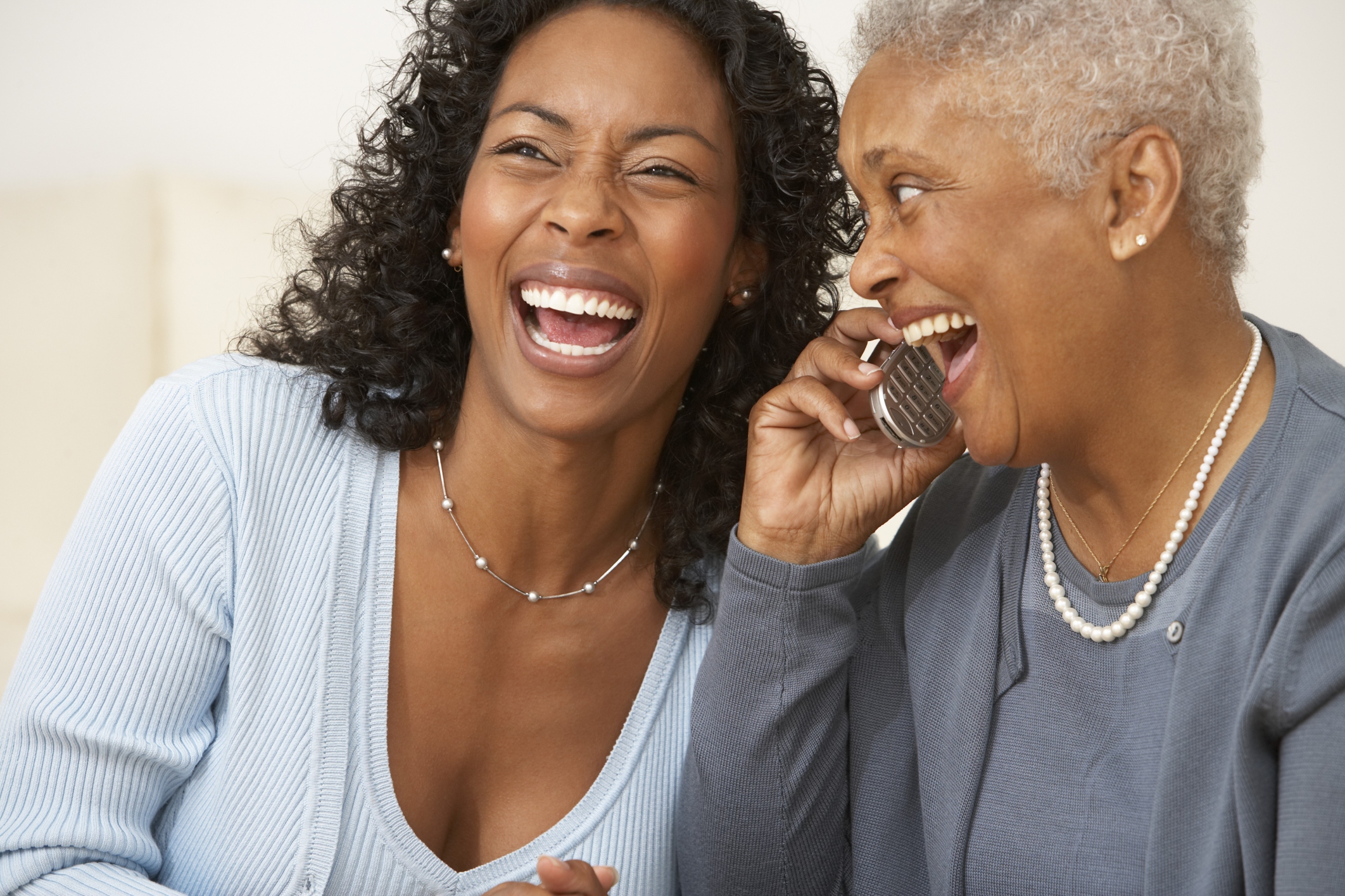 Mother and Daughter Telephoning Together