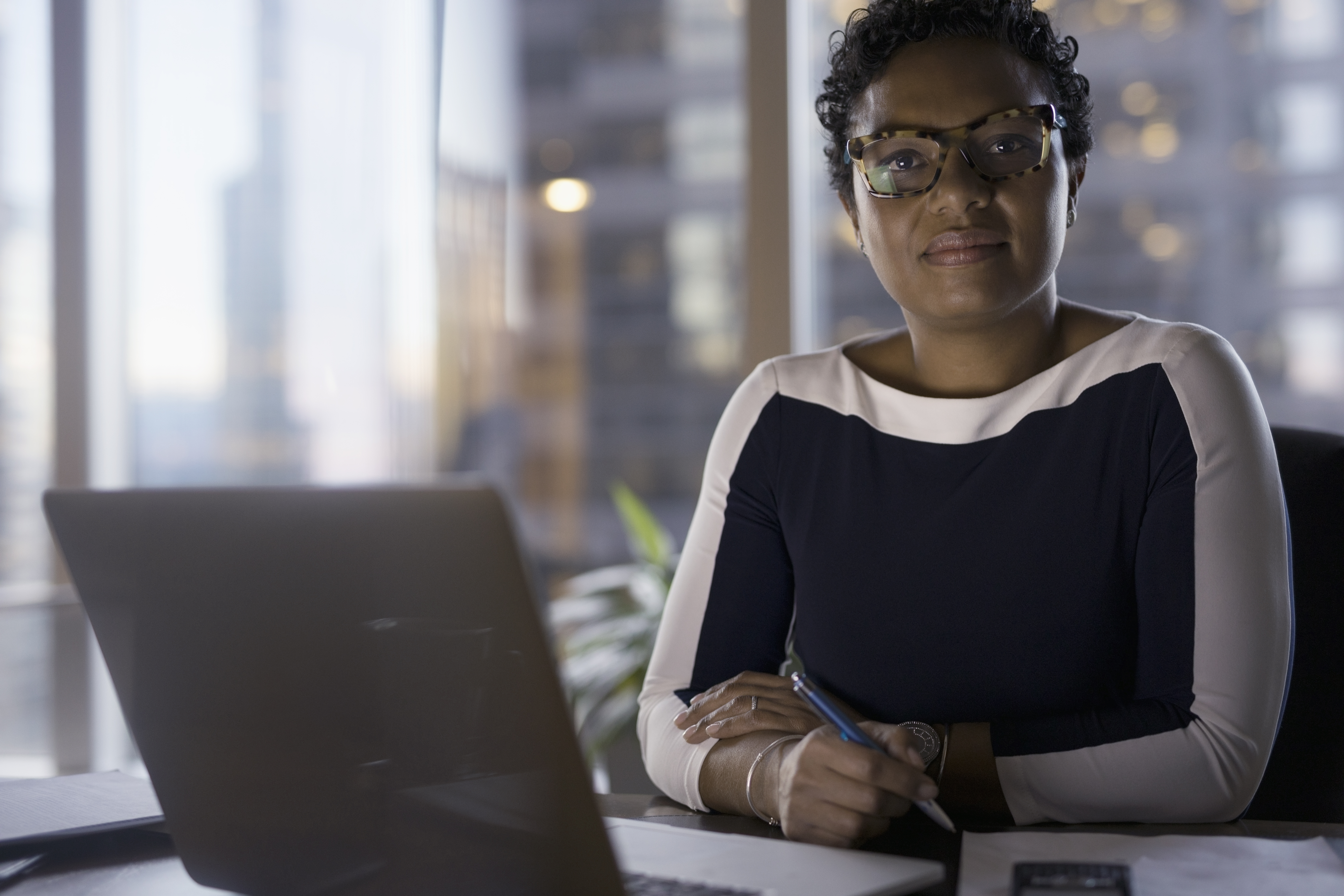 Portrait confident female lawyer working at laptop
