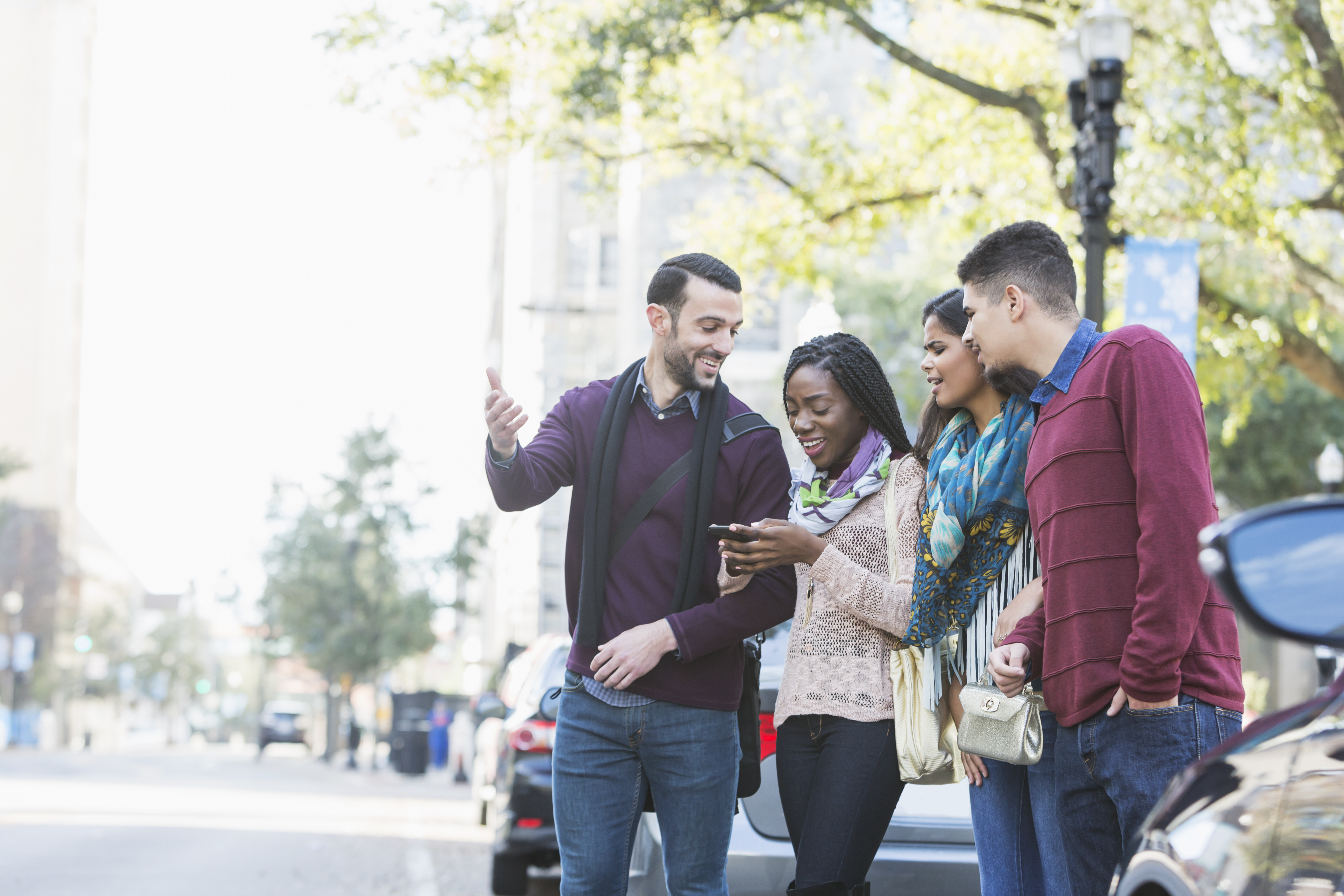 Multi-ethnic group of young adults waiting for ride