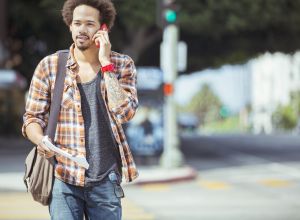 Man talking on cell phone in urban crosswalk