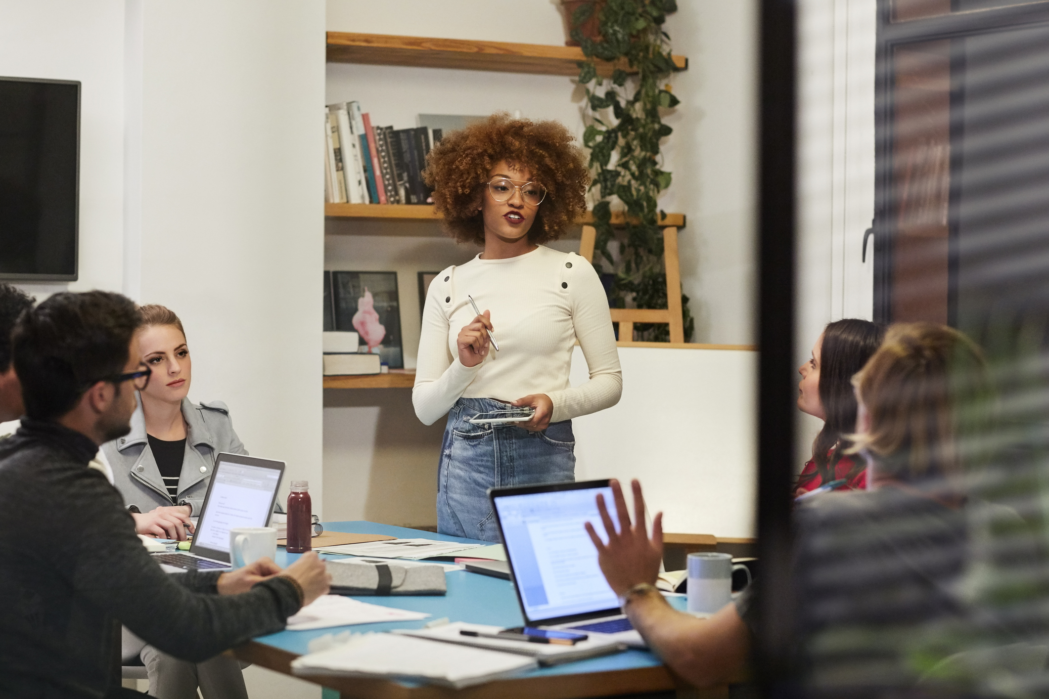 Female executive talking to colleagues in meeting