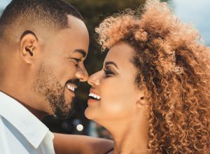 Afro couple kissing outdoors