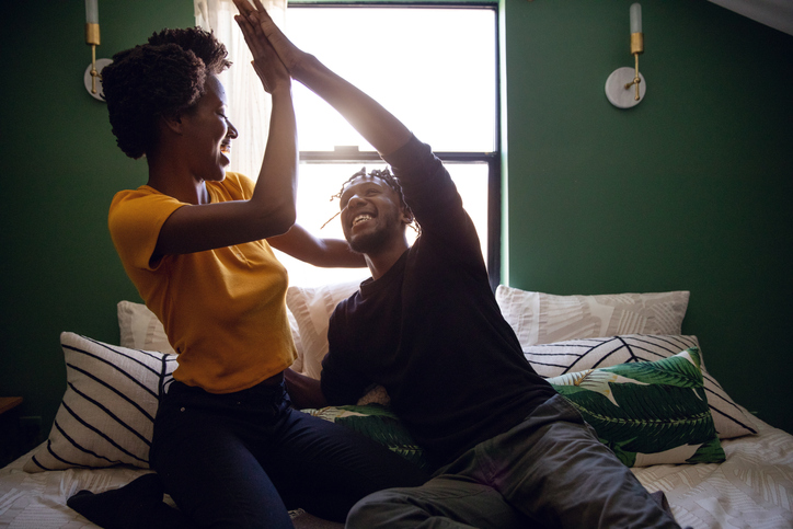 Lovely afro american couple spending happy time together at home