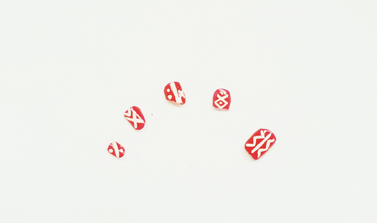 Close-Up Of Artificial Nails Over White Background