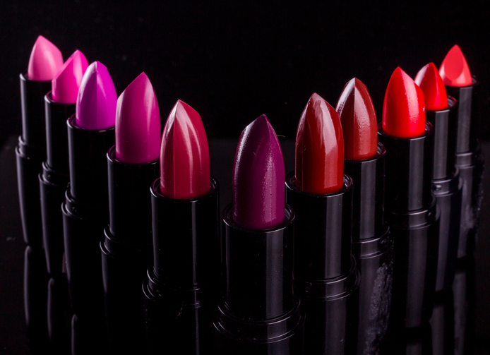 Close-Up Of Various Lipsticks Against Black Background