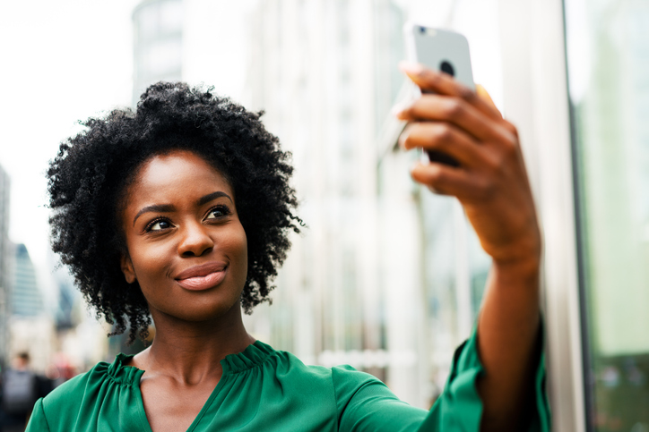 Woman takes selfie in city