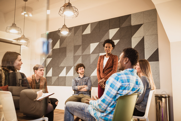Counseling. Young woman talking in group therapy session