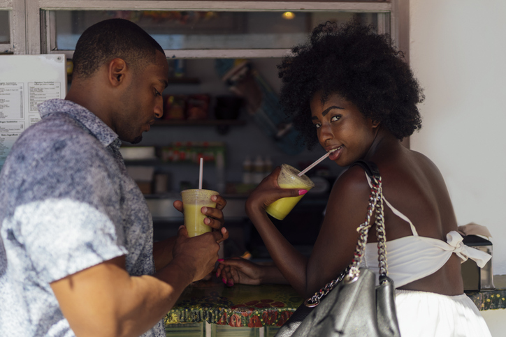 Young couple having a drink at a kiosk