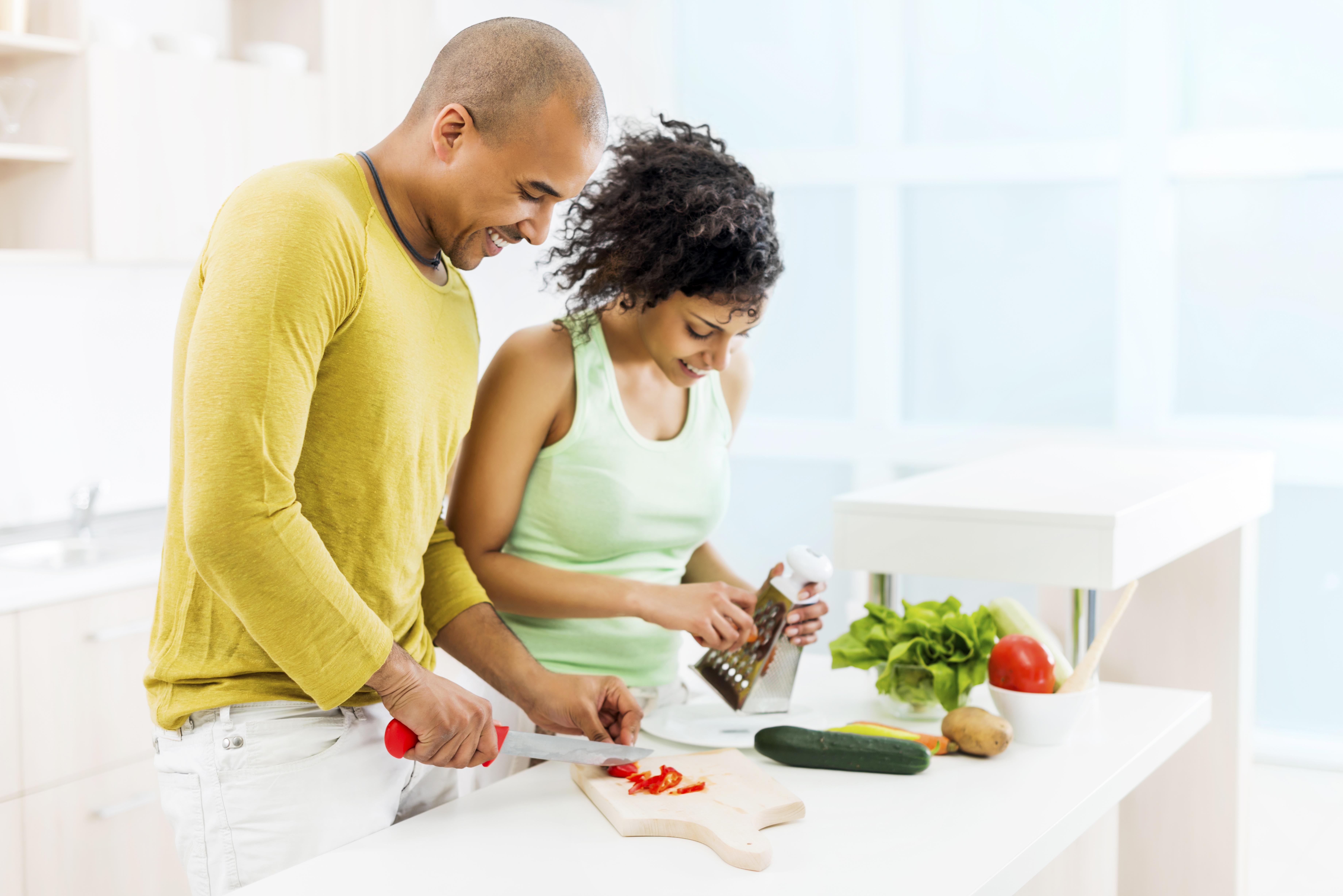 Couple preparing food in kitchen.