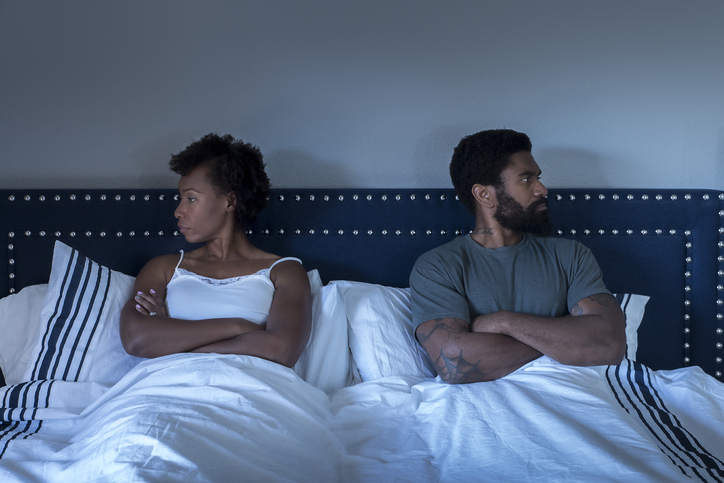 Man and woman sitting in bed