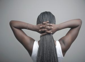 Rear view portrait African American woman with long black braids