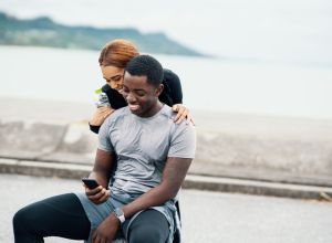 Young couple looking at a smart phone before or after running or jogging