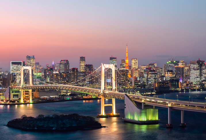 Rainbow Bridge spanning Tokyo Bay with Tokyo Tower visible in the background , Japan