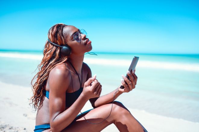 Sensual Female Listening To Relaxing Music At The Beach