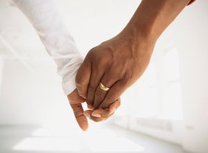 Couple holding hands in empty room