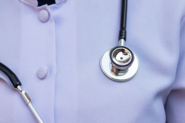 Midsection Of Doctor With Stethoscope In Hospital