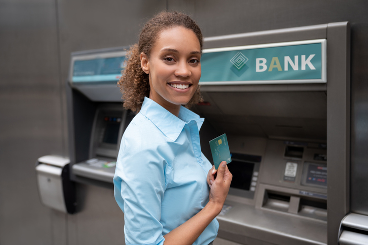 Business woman making a cash withdrawal at an ATM