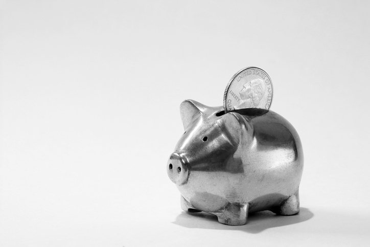 Small metal piggy bank with American quarter coin