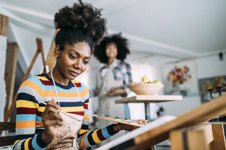 Female fine artists drawing in studio