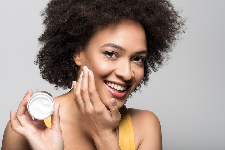 Woman applying moisturizer