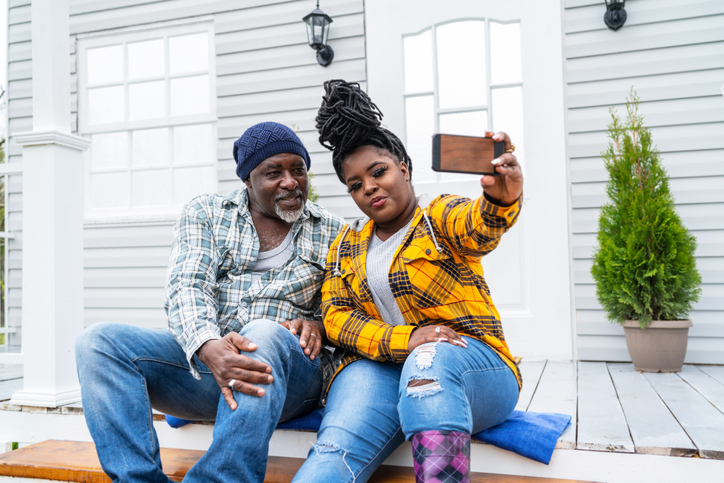 Father and daughter hanging out on the porch.