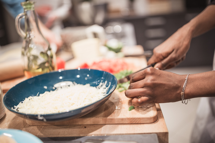 African - American woman chopping vegetables