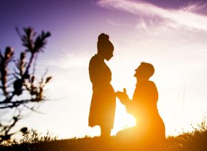 Diverse Couple Engagement Silhouettes at Sunset