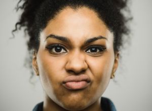 Close-up portrait of displeased young afro american woman