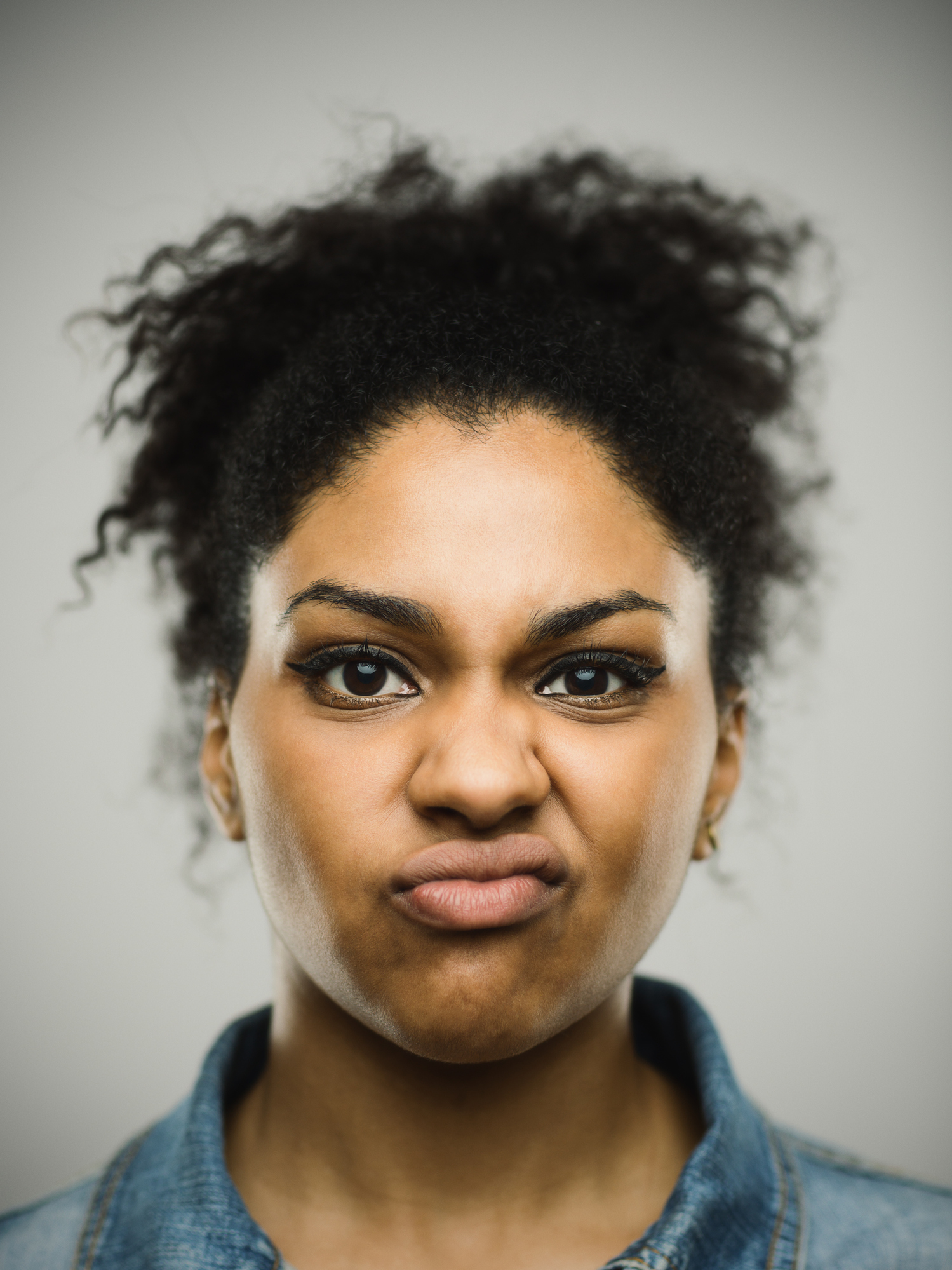 Close-up portrait of displeased young afro american woman