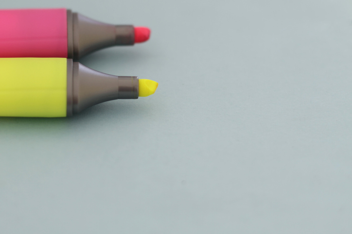 Pink and Yellow highlighter on blue background