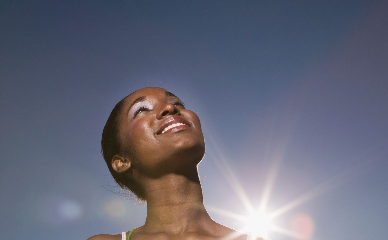 African woman holding aloe plant