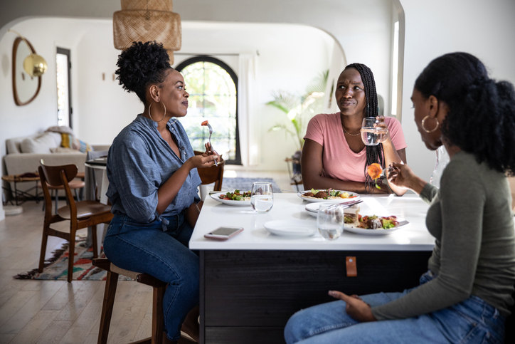 Women friends enjoying a lunch together at home