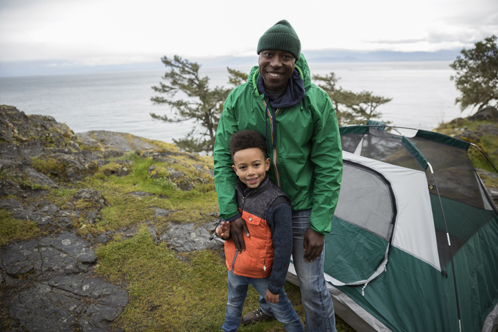 Portrait smiling father and son camping