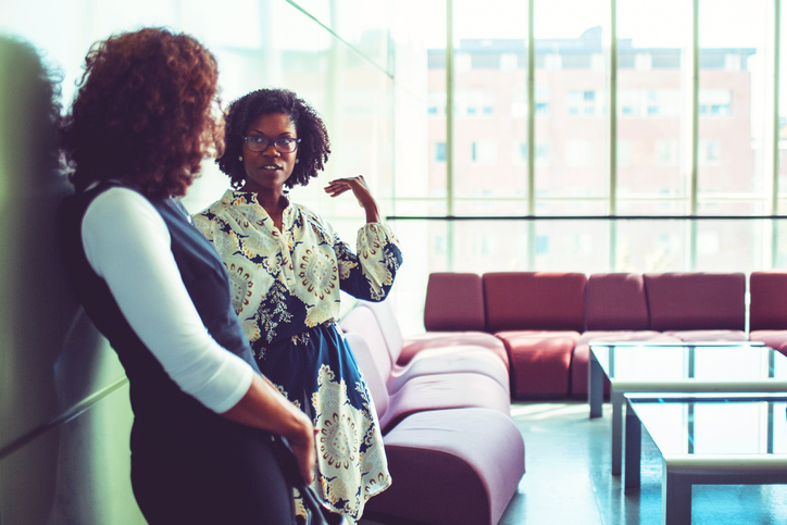 Businesswomen talking in the office building lobby