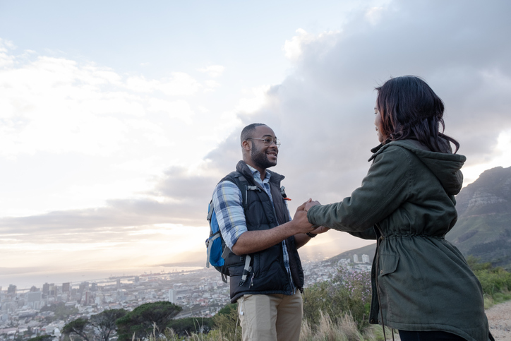 Smiling couple holding hands on Table Mountain