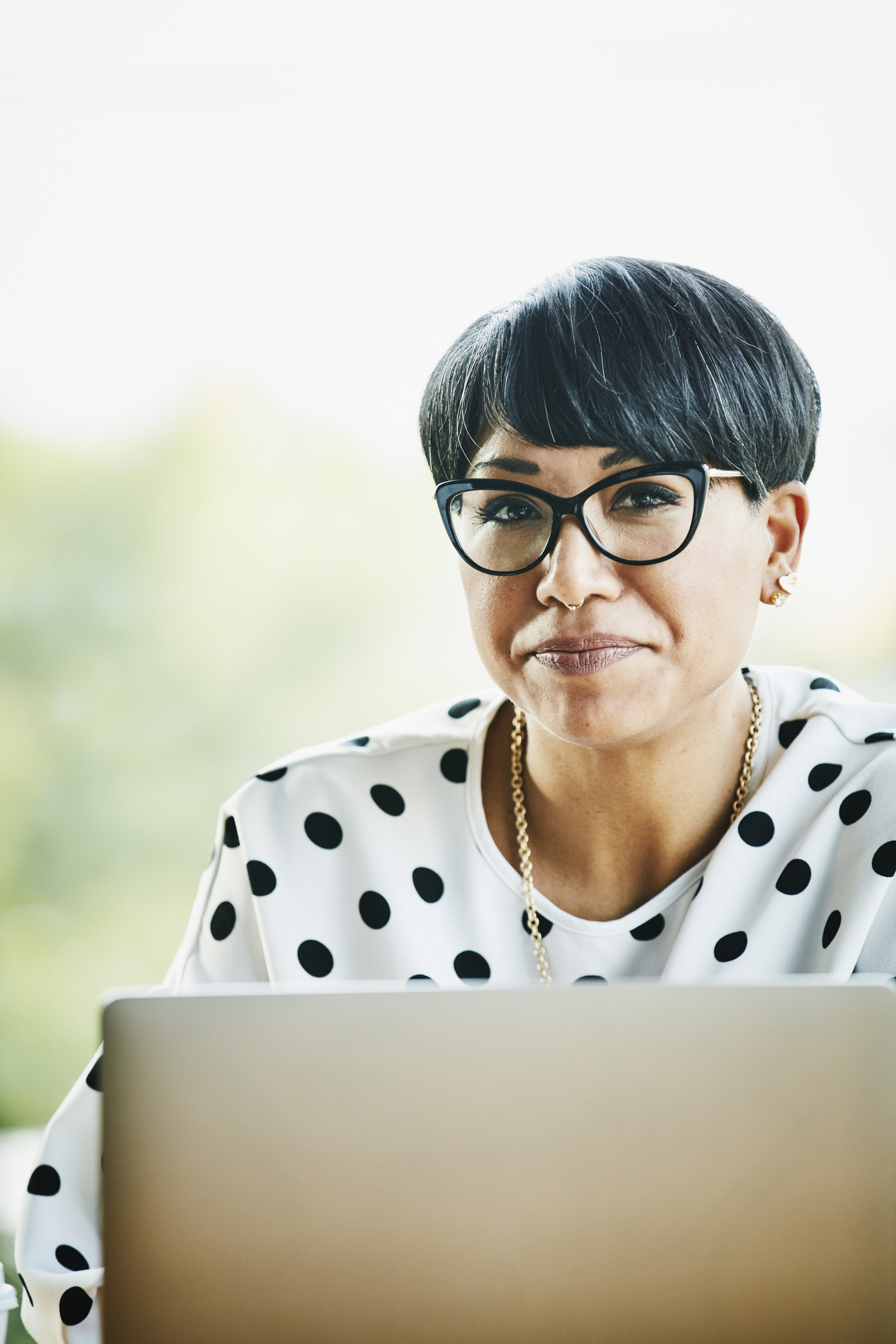 Portrait of smiling mature businesswoman working on laptop