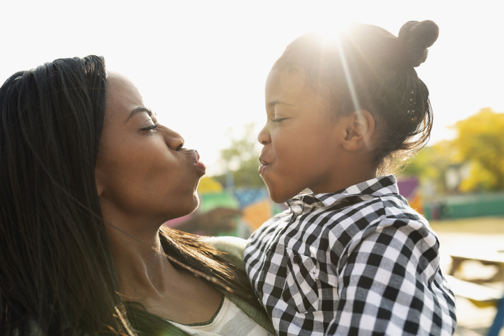 Playful mother and daughter making faces