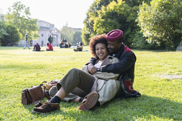 Loving couple hugging on grass, Milan, Italy