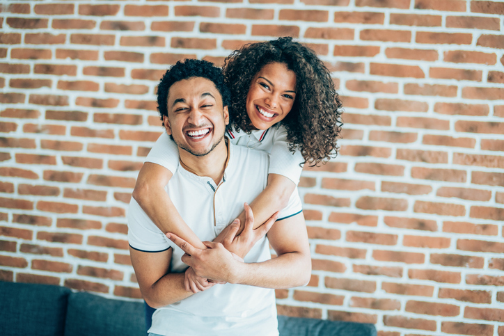 Beautiful black woman embracing her boyfriend