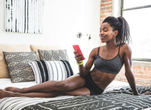 Afro american woman chilling out on the bed after work out