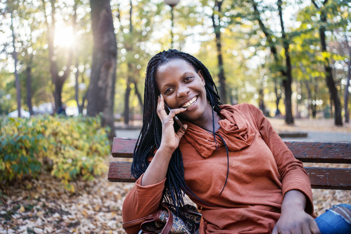 African woman in the autumn park