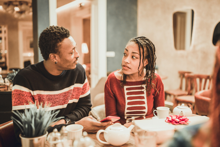 Two diverse couples, gathering in the restaurant.